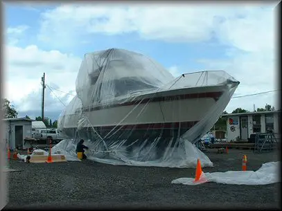428accb115ab2fdd358f1ce81e5cfe9a A boat covered in plastic and being hauled